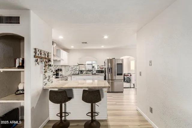 a kitchen with stainless steel appliances a refrigerator sink and stove