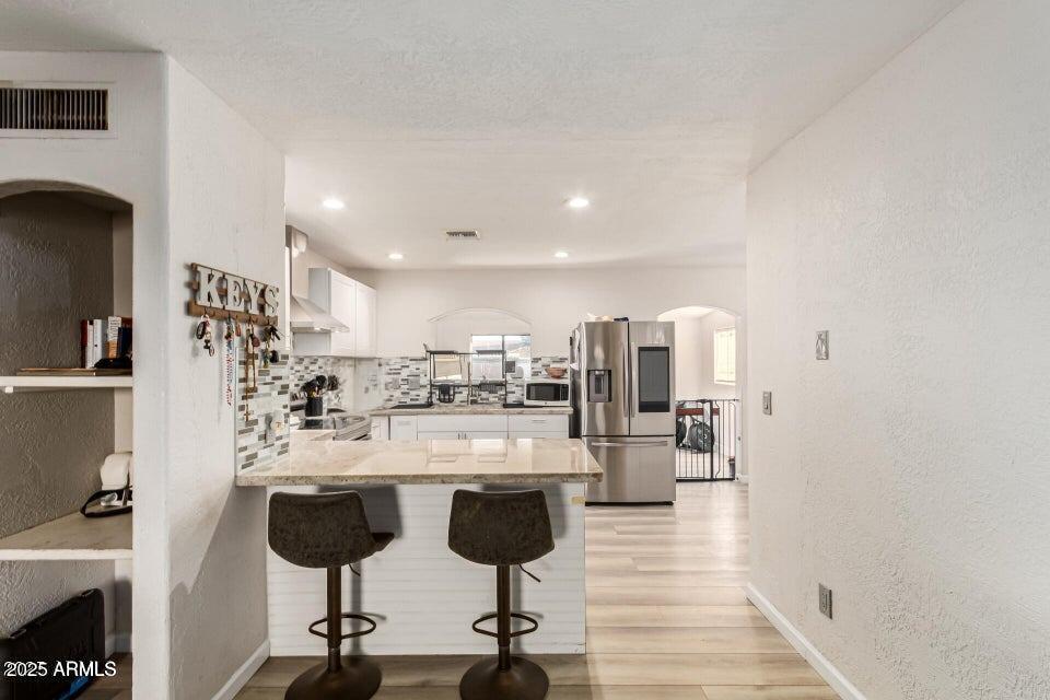 677 West 22nd Avenue Apache Junction, AZ 85120 - Photo 15 of 21 a kitchen with stainless steel appliances kitchen island hardwood floor and a sink