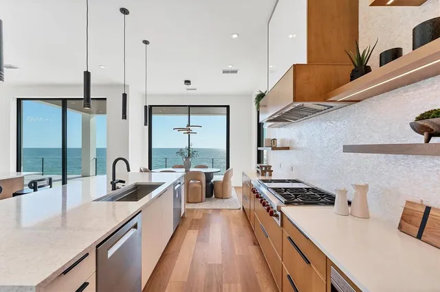 a living room with furniture a table and wooden floor