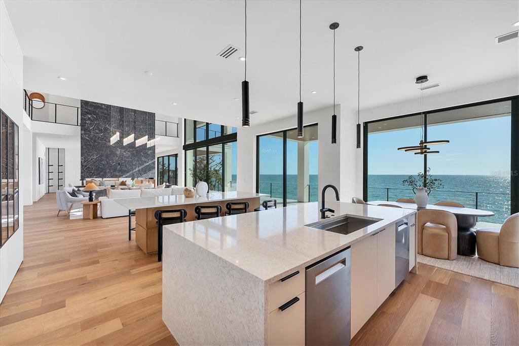 4005 Casey Key Road Nokomis, FL 34275 - Photo 15 of 84 a kitchen with stainless steel appliances granite countertop sink stove and wooden floor