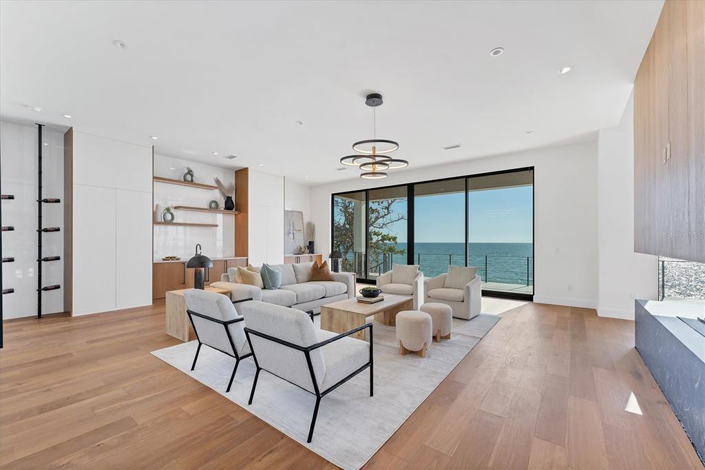4005 Casey Key Road Nokomis, FL 34275 - Photo 17 of 84 a living room with furniture wooden floor and a large window