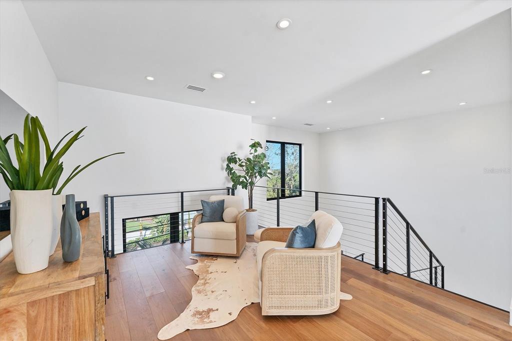 4005 Casey Key Road Nokomis, FL 34275 - Photo 21 of 84 a living room with furniture potted plant and wooden floor