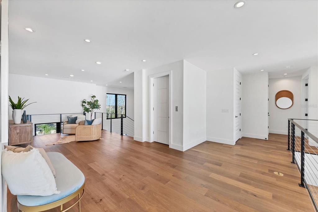 4005 Casey Key Road Nokomis, FL 34275 - Photo 22 of 84 a living room with furniture a table and wooden floor