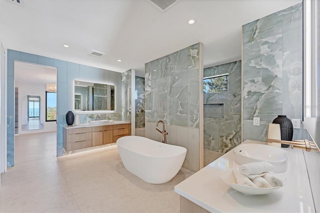 4005 Casey Key Road Nokomis, FL 34275 - Photo 28 of 84 a bathroom with a double vanity sink bathtub and shower