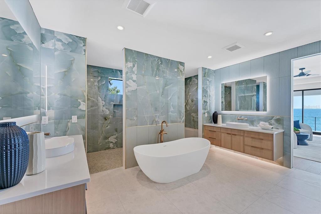 4005 Casey Key Road Nokomis, FL 34275 - Photo 30 of 84 a bathroom with a tub a toilet a sink and glass door