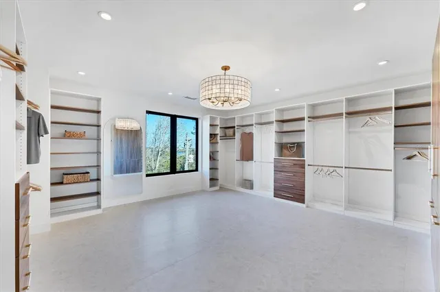a spacious bathroom with a shower sink and mirror