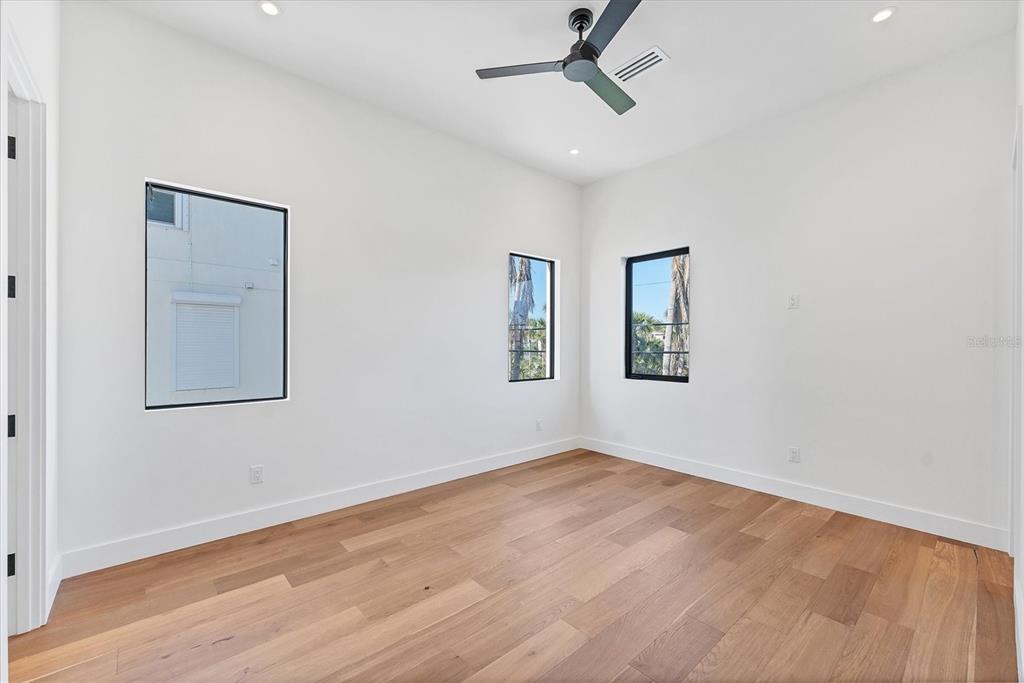 4005 Casey Key Road Nokomis, FL 34275 - Photo 32 of 84 a view of empty room with wooden floor and fan