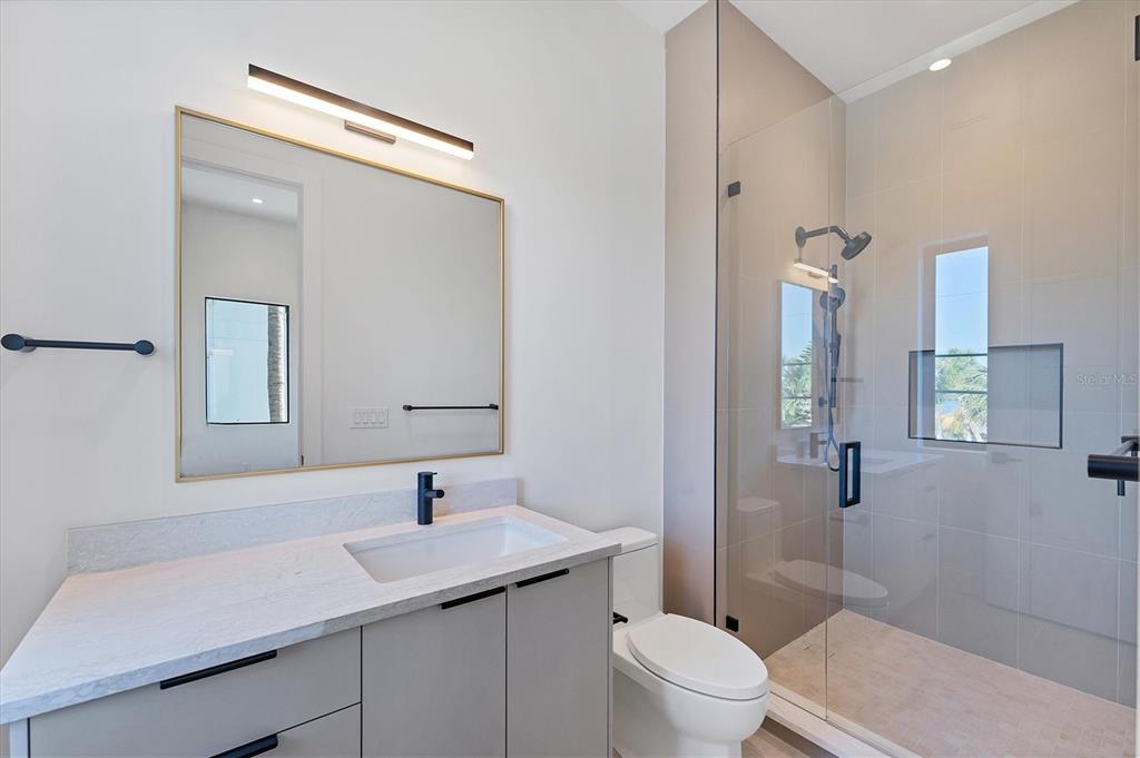 4005 Casey Key Road Nokomis, FL 34275 - Photo 34 of 84 a bathroom with a sink toilet and shower