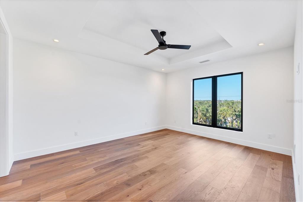 4005 Casey Key Road Nokomis, FL 34275 - Photo 38 of 84 an empty room with wooden floor and windows