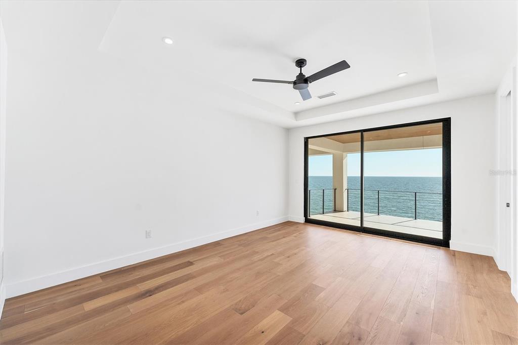 4005 Casey Key Road Nokomis, FL 34275 - Photo 42 of 84 an empty room with wooden floor and windows