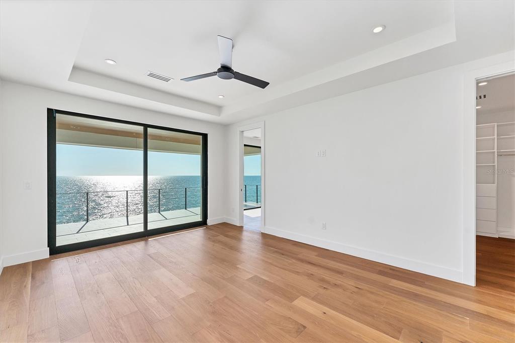 4005 Casey Key Road Nokomis, FL 34275 - Photo 43 of 84 an empty room with wooden floor and windows
