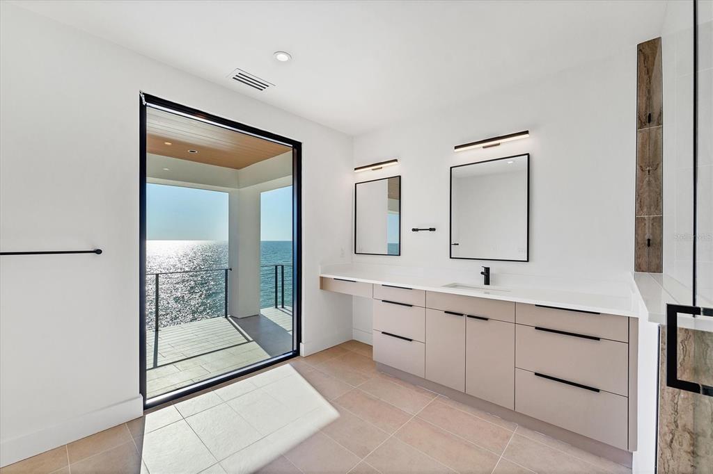 4005 Casey Key Road Nokomis, FL 34275 - Photo 45 of 84 a spacious bathroom with a double vanity sink and a mirror
