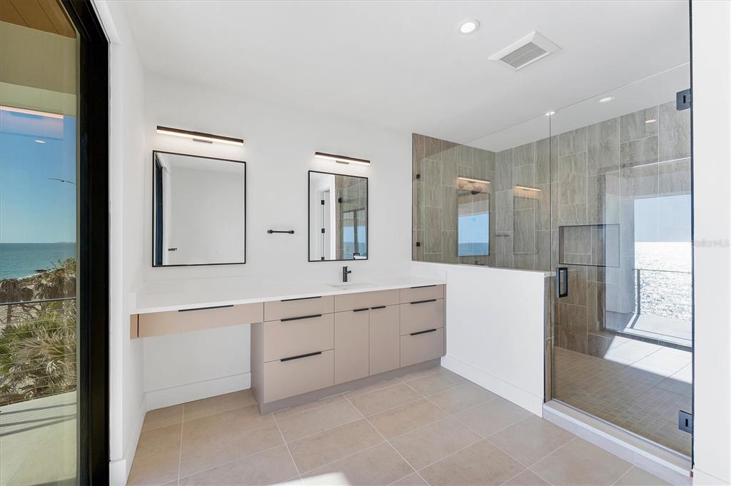 4005 Casey Key Road Nokomis, FL 34275 - Photo 47 of 84 a large bathroom with a large mirror vanity and shower