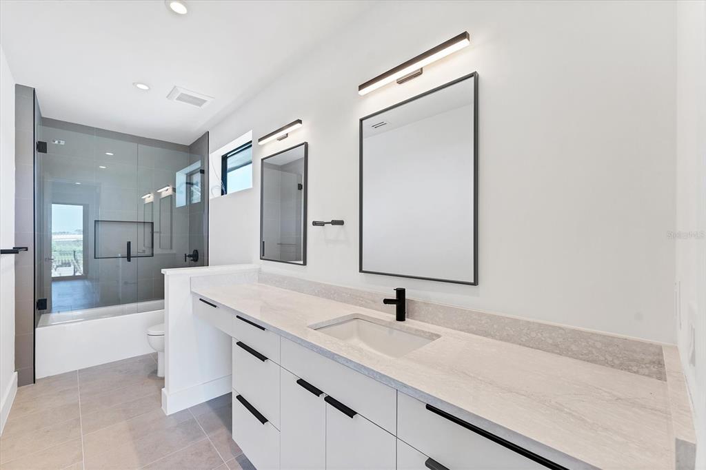 4005 Casey Key Road Nokomis, FL 34275 - Photo 50 of 84 a bathroom with a sink and a mirror