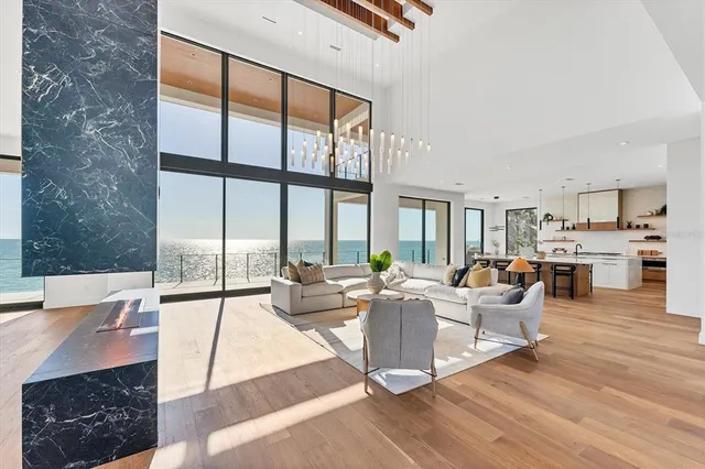 a dining room with furniture a chandelier and wooden floor