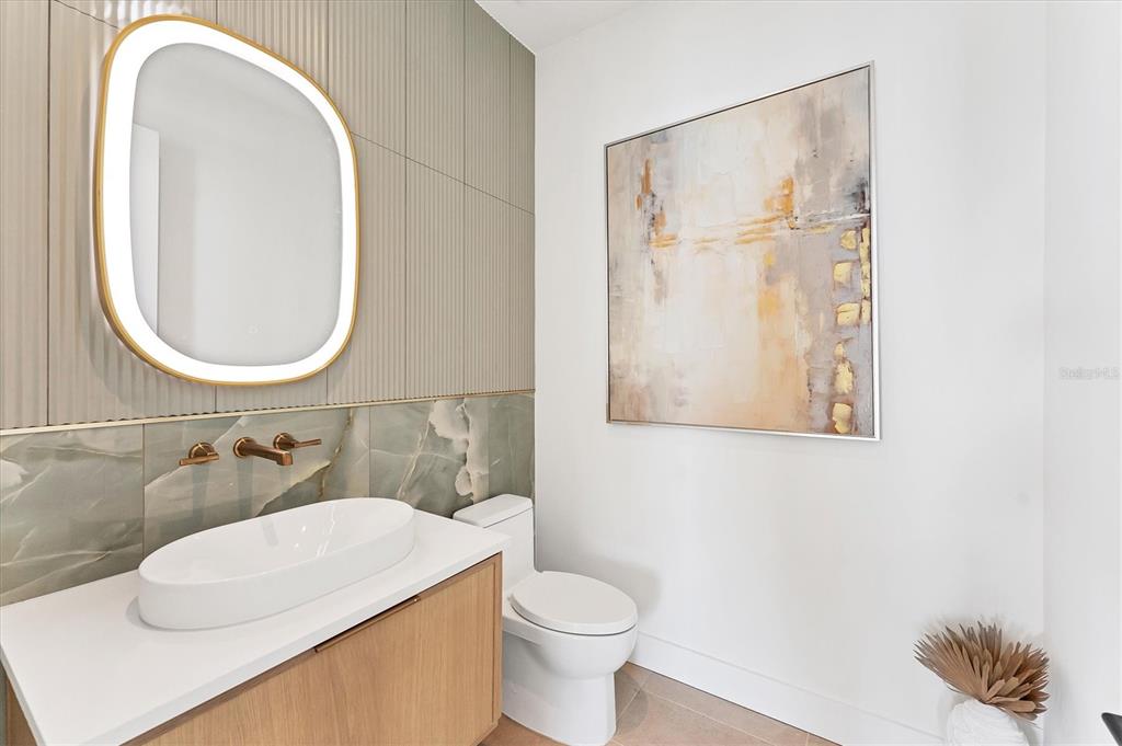 4005 Casey Key Road Nokomis, FL 34275 - Photo 52 of 84 a bathroom with a toilet sink and mirror