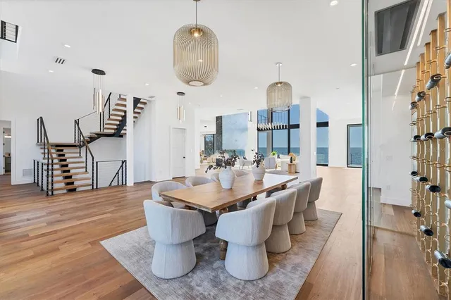 a living room with furniture wooden floor and a large window