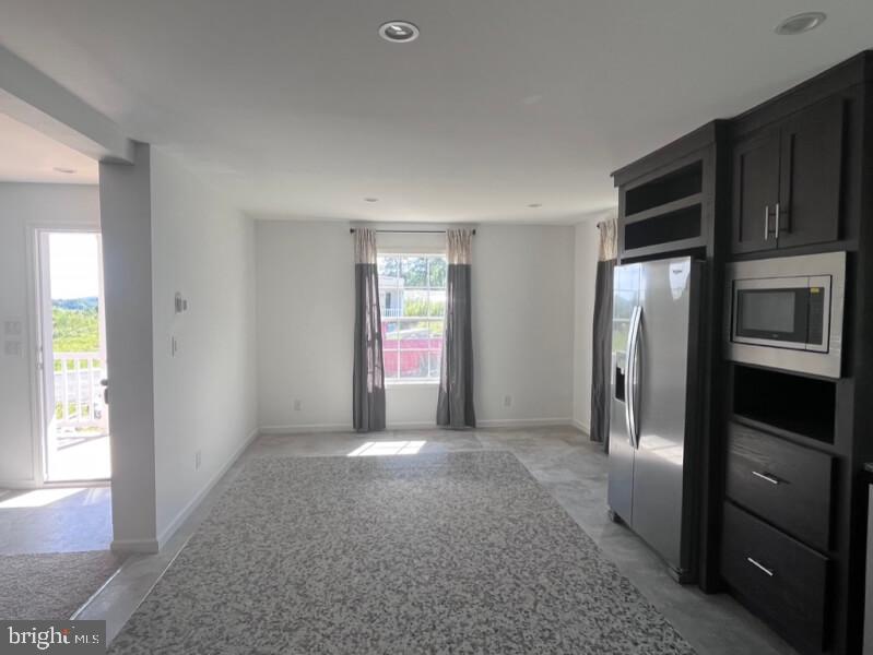 136 Minch Road Parkesburg, PA 19365 - Photo 9 of 17 a view of an empty room with a kitchen