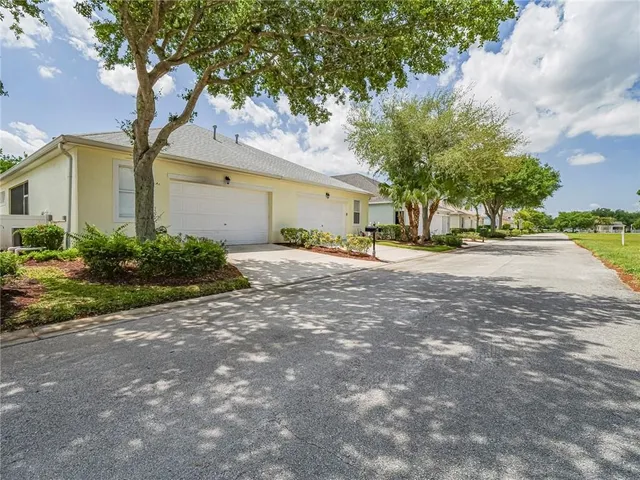 a front view of a house with a yard and a garage