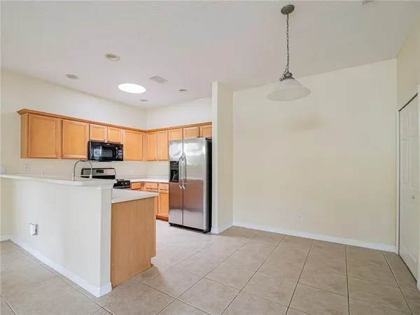 a kitchen with stainless steel appliances a refrigerator sink and microwave