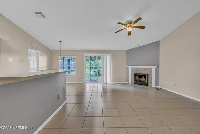 a view of a kitchen with a sink and a fireplace