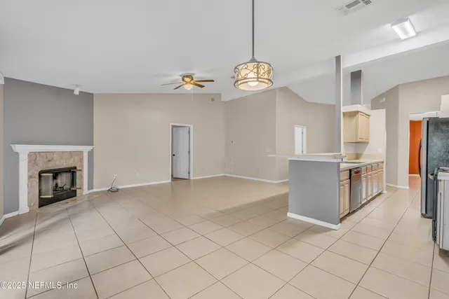 a kitchen with stainless steel appliances granite countertop a refrigerator and a stove