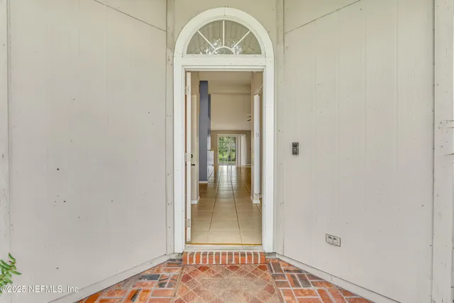 a view of an entryway with wooden floor