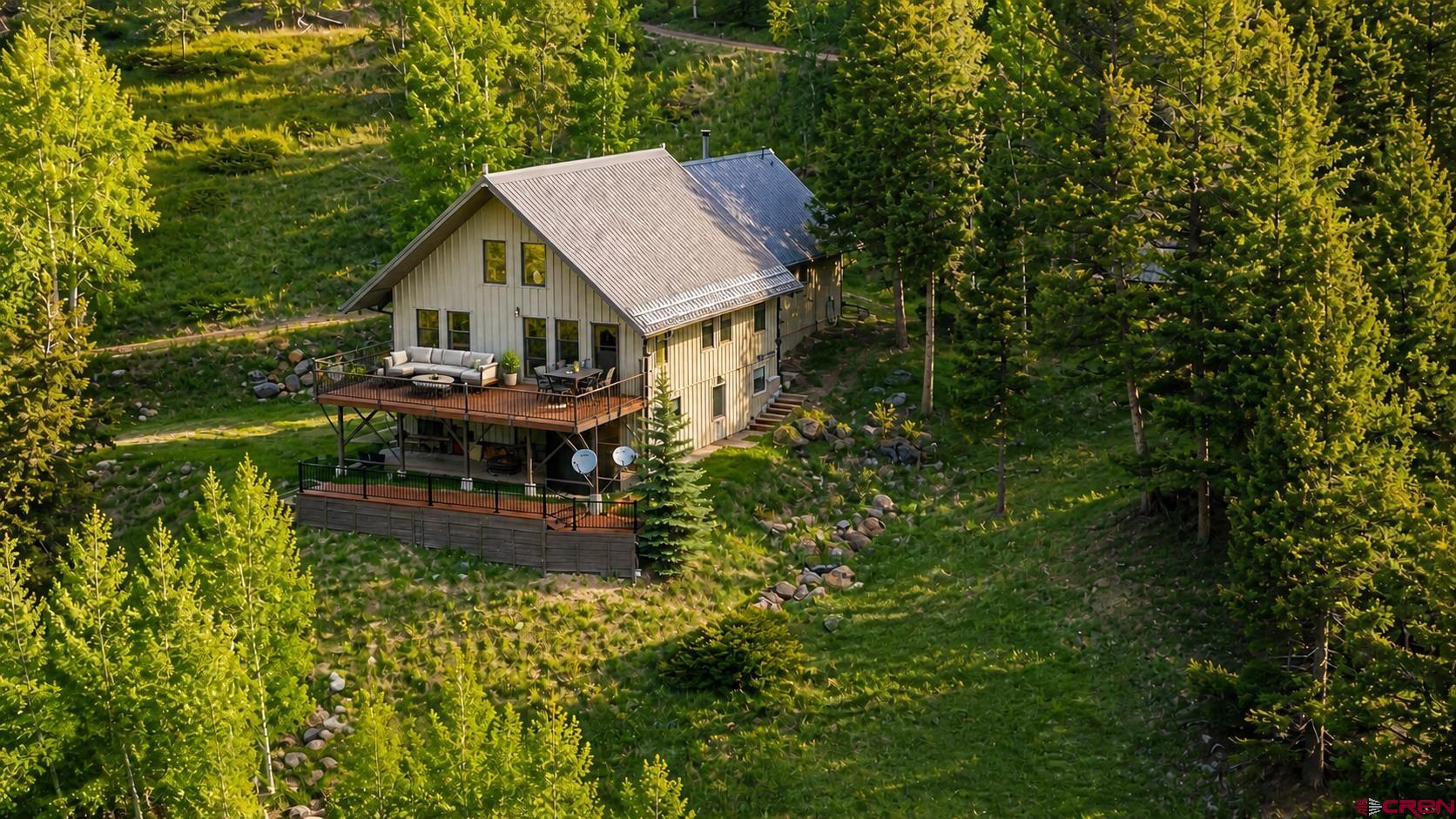 1113 Spring Street Del Norte, CO 81132 - Photo 1 of 43 a view of a house with backyard and sitting area