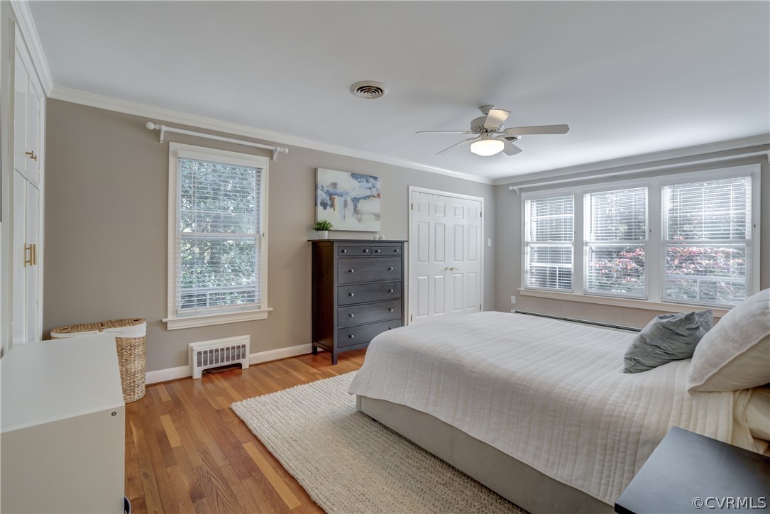 8505 Julian Road Henrico, VA 23229 - Photo 25 of 44 a spacious bedroom with a large bed a chandelier and windows