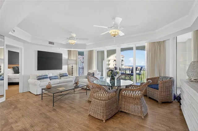 a living room with furniture a flat screen tv and kitchen view