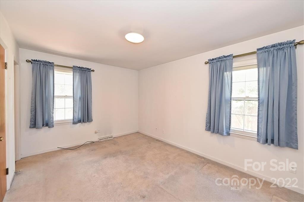 5714 Sharon Road Charlotte, NC 28210 - Photo 13 of 22 an empty room with windows