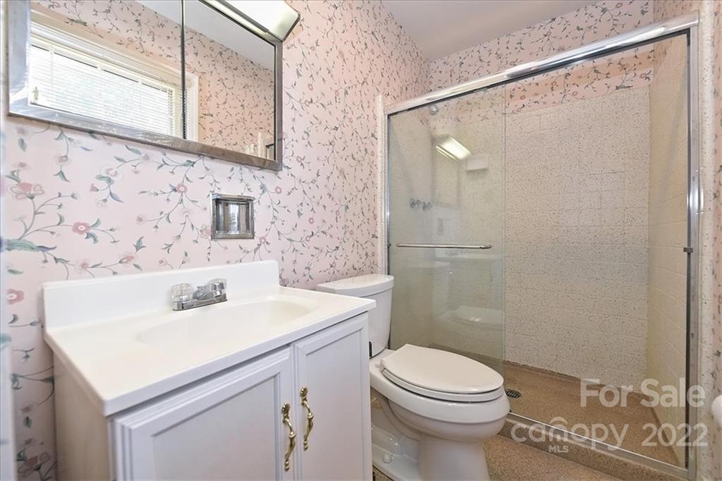 5714 Sharon Road Charlotte, NC 28210 - Photo 15 of 22 a bathroom with a sink a toilet and shower