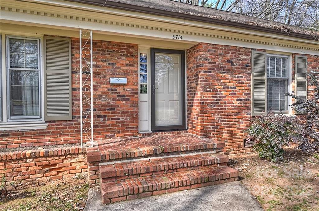 5714 Sharon Road Charlotte, NC 28210 - Photo 2 of 22 a front view of a house with a yard