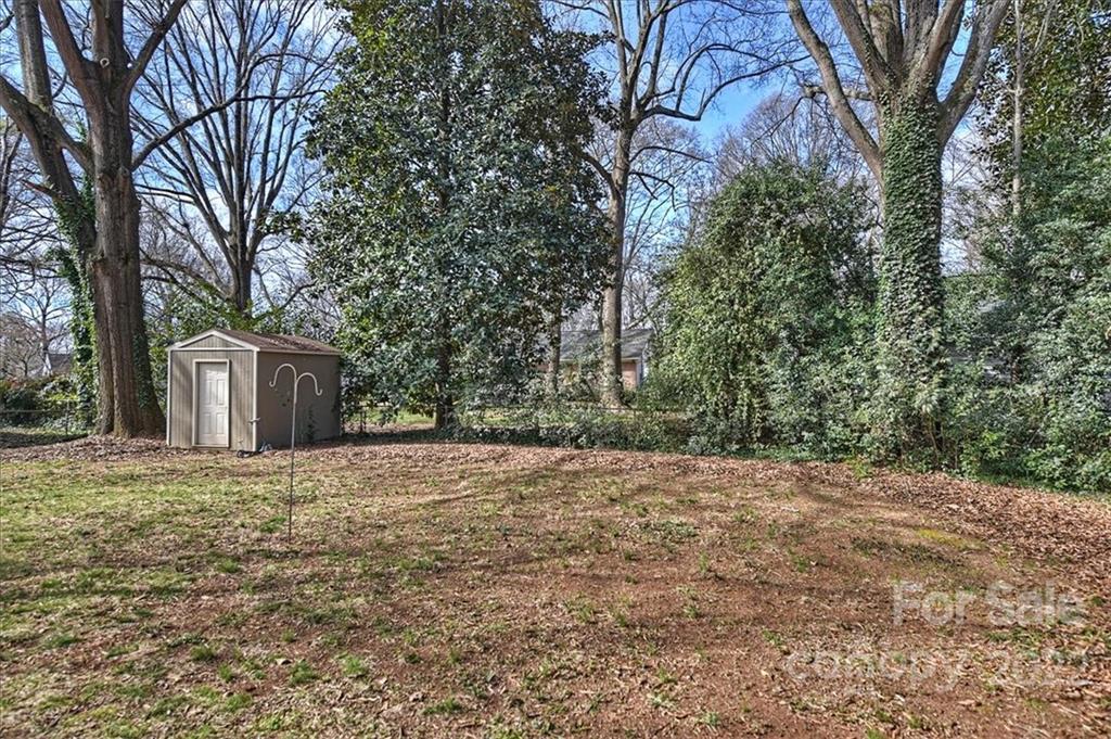 5714 Sharon Road Charlotte, NC 28210 - Photo 22 of 22 a big house with large trees and plants