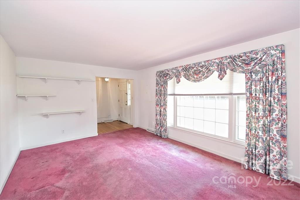 5714 Sharon Road Charlotte, NC 28210 - Photo 4 of 22 an empty room with a window