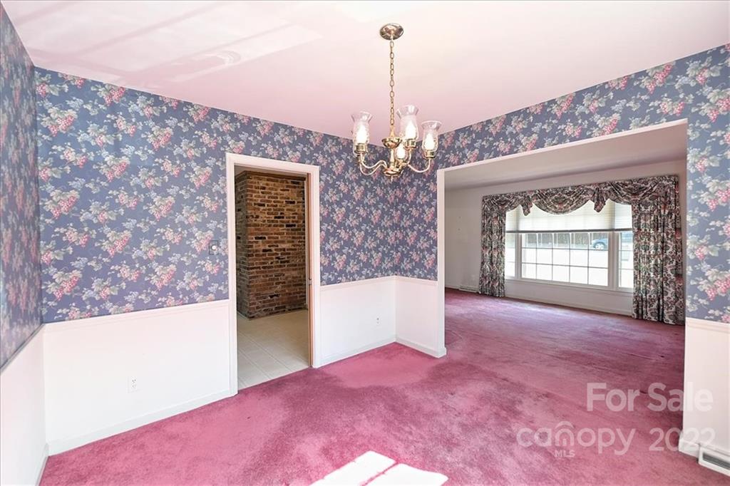 5714 Sharon Road Charlotte, NC 28210 - Photo 6 of 22 a view of a big room with windows and chandelier