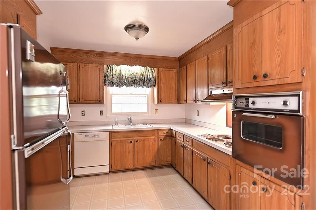 5714 Sharon Road Charlotte, NC 28210 - Photo 8 of 22 a kitchen with a sink stove and cabinets
