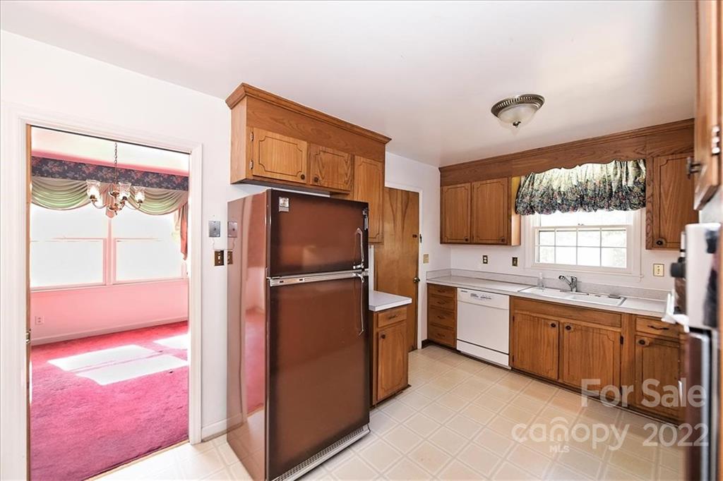 5714 Sharon Road Charlotte, NC 28210 - Photo 9 of 22 a kitchen with a refrigerator sink and stove
