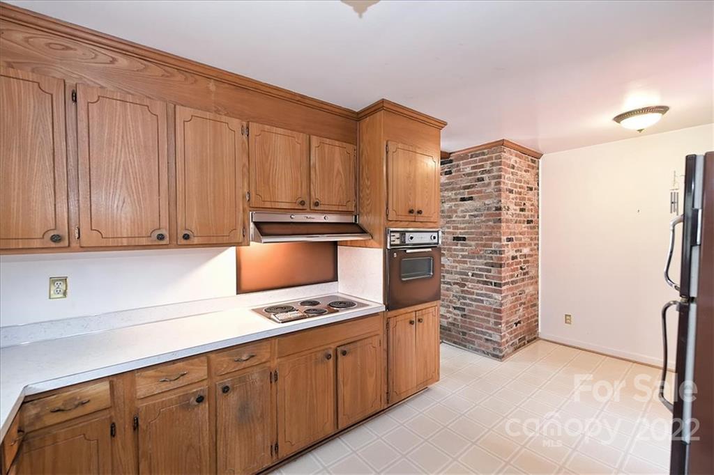 5714 Sharon Road Charlotte, NC 28210 - Photo 10 of 22 a kitchen with stainless steel appliances a refrigerator and cabinets