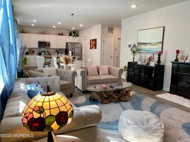 a living room with furniture and kitchen view