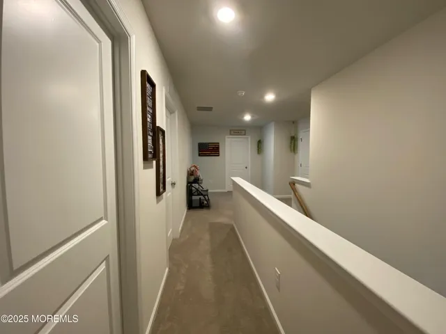 a bathroom with a bathtub and a hallway