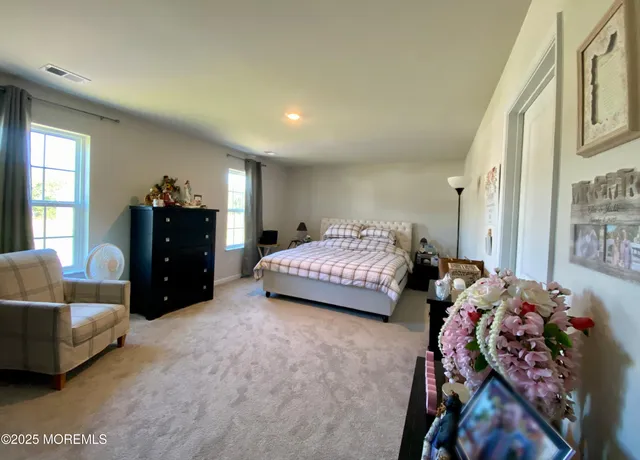 a bedroom with bed and a couch