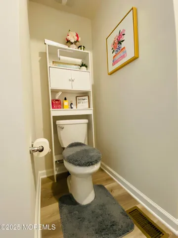 a bathroom with a toilet and a cabinets
