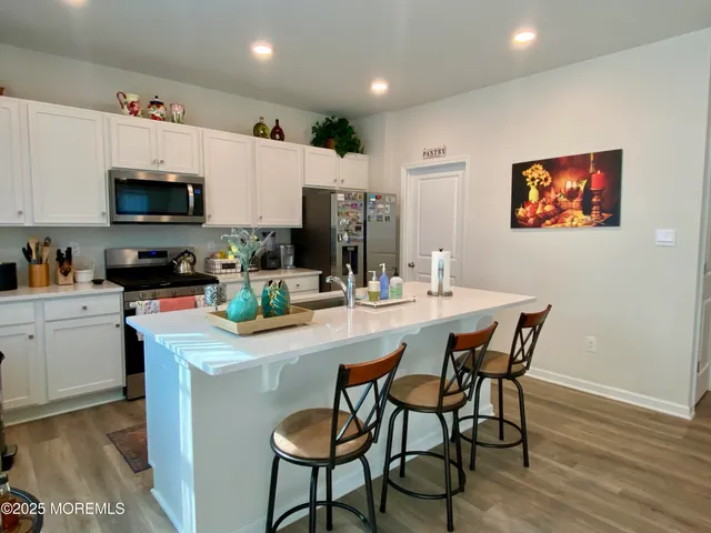 a kitchen with stainless steel appliances a microwave a sink and a stove