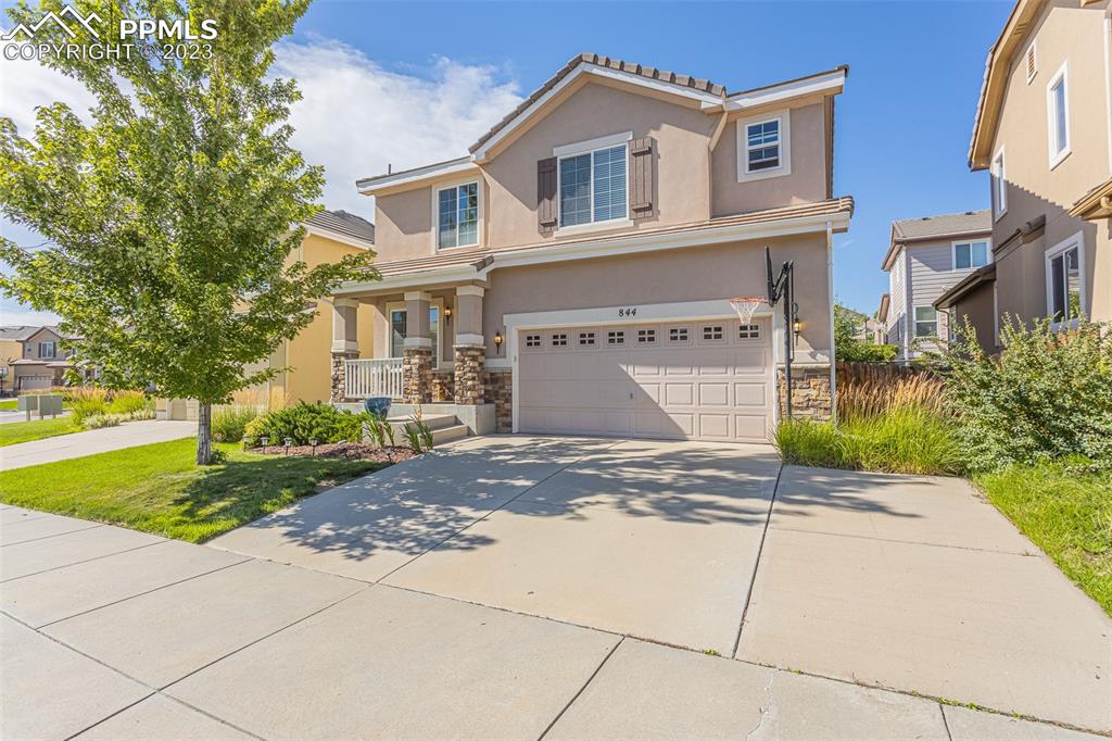 a front view of a house with a yard and garage