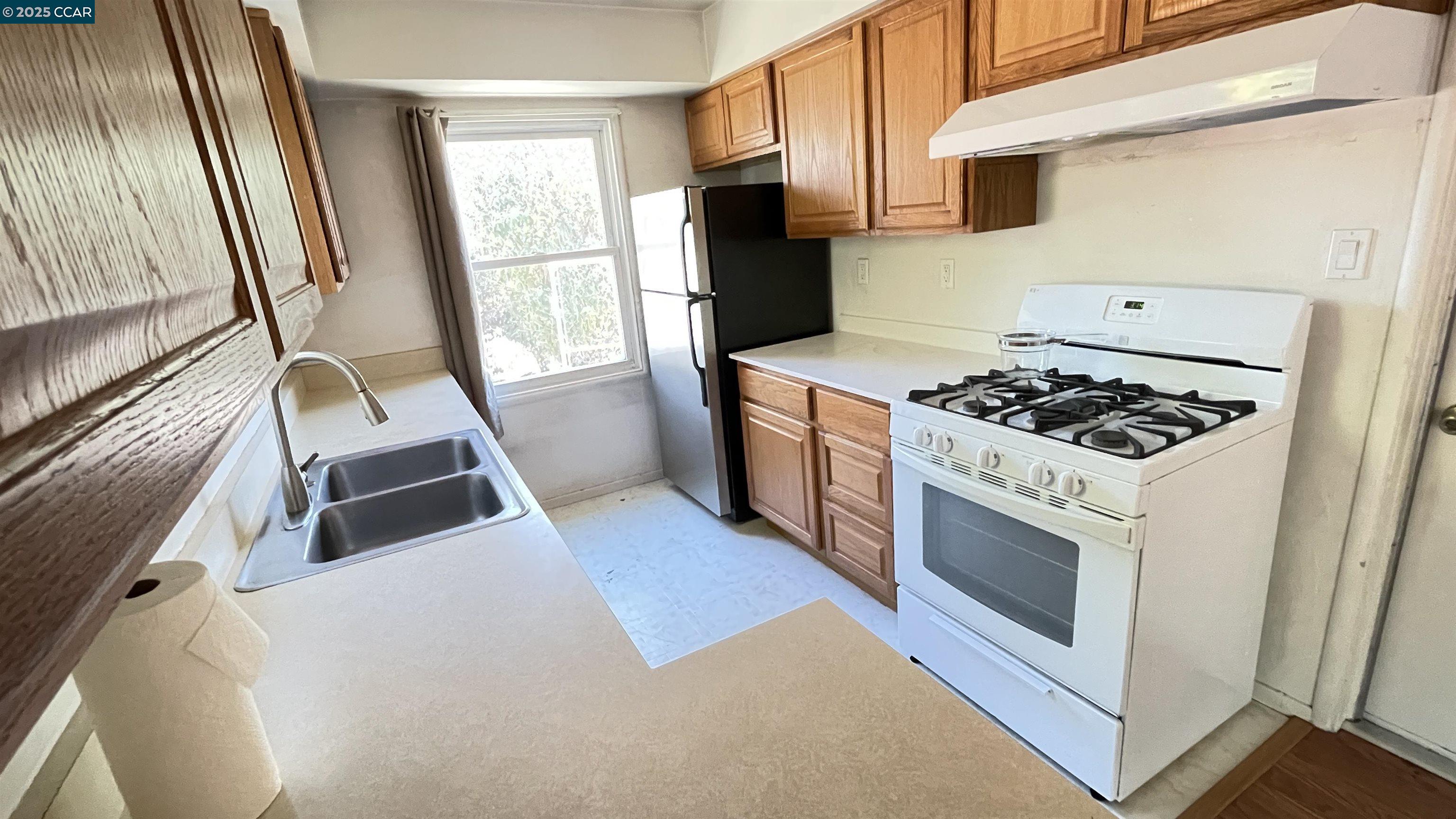 3655 Granzotto Drive Concord, CA 94519 - Photo 8 of 22 a kitchen with wooden cabinets and a stove top oven