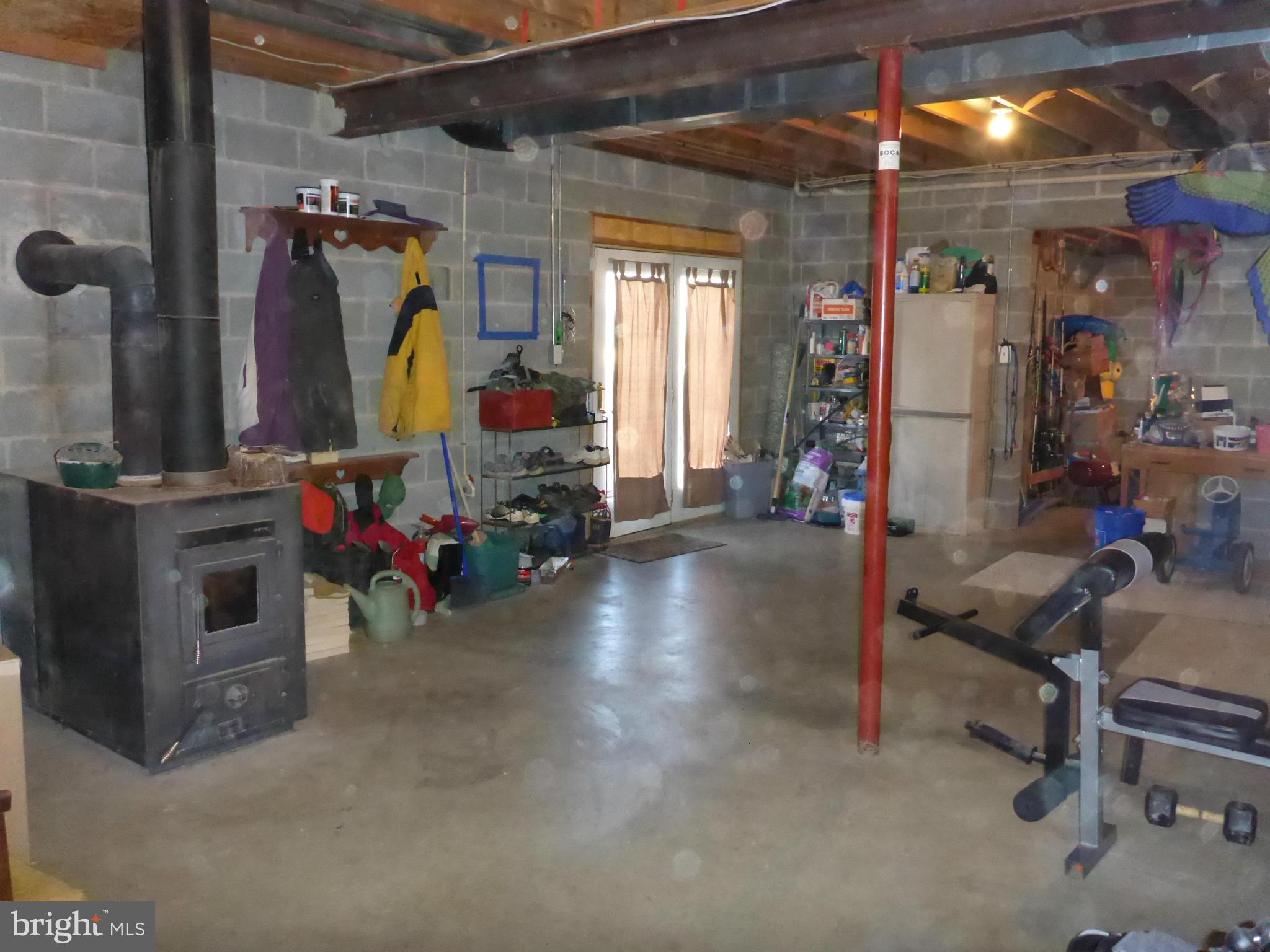 458 McCauley Road Conowingo, MD 21918 - Photo 17 of 30 Basement with Wood stove and bathroom rough-in