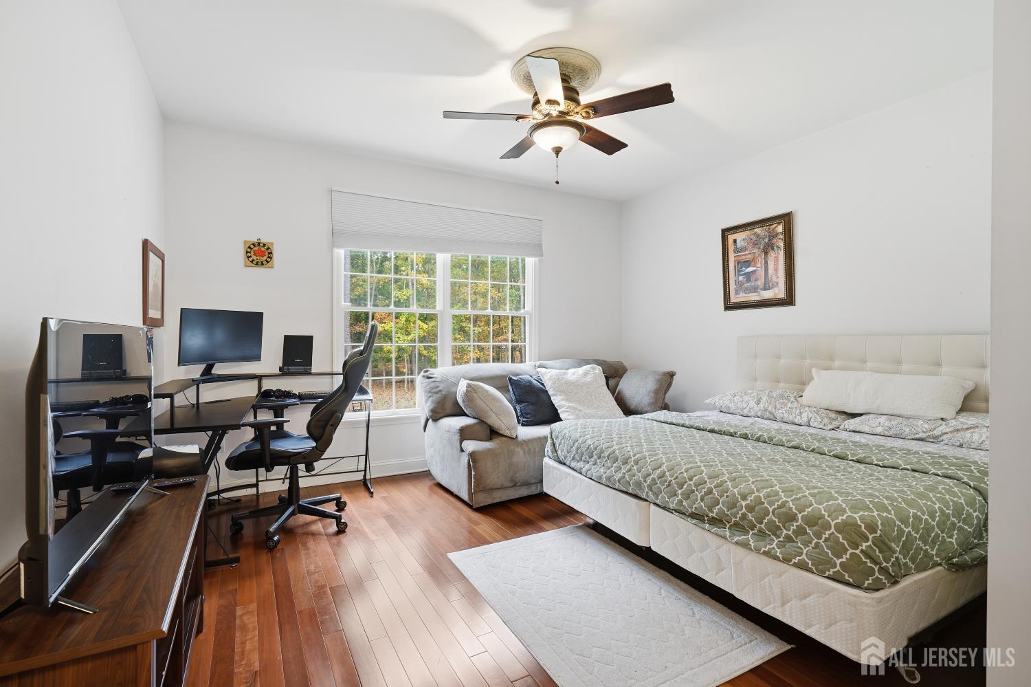 12 Risa Benjamin Way Freehold, NJ 07728 - Photo 18 of 32 a bedroom with a large bed and a wooden floor