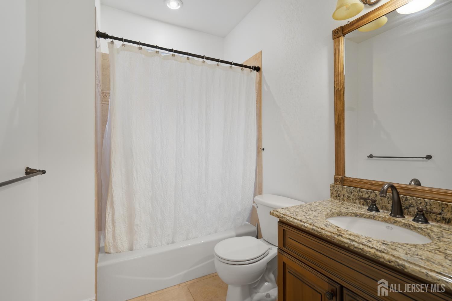 12 Risa Benjamin Way Freehold, NJ 07728 - Photo 22 of 32 a bathroom with a granite countertop sink and a mirror