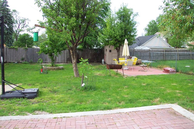 778 Spring Street Aurora, IL 60505 - Photo 7 of 16 a backyard of a house with table and chairs